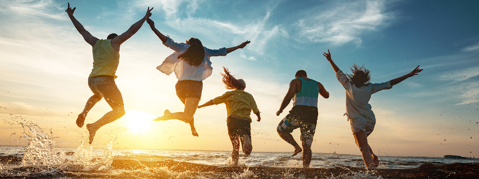 Five happy friends runs and jumps to sunset lake beach after party.